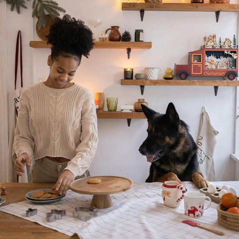 A dog owner baking homemade healthy dog treat recipes for Valentine's Day